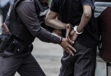 Police Officer Handcuffs A Man