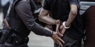 Police Officer Handcuffs A Man