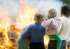 People standing in front of a fire