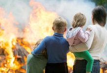 People standing in front of a fire