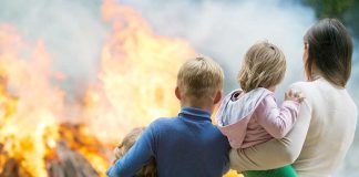 People standing in front of a fire