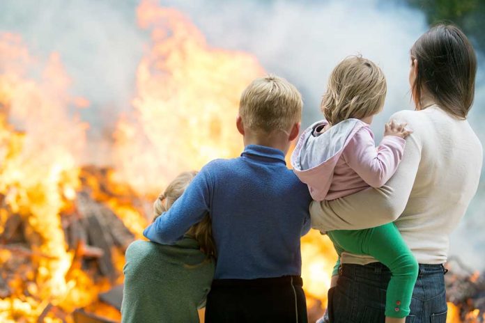 People standing in front of a fire