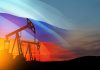 Oil rigs with Russian flag at sunset background