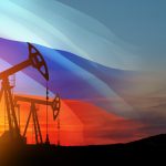 Oil rigs with Russian flag at sunset background