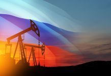 Oil rigs with Russian flag at sunset background