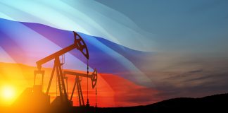 Oil rigs with Russian flag at sunset background