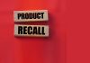 Product recall text on wooden blocks red background