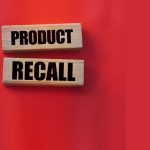 Product recall text on wooden blocks red background