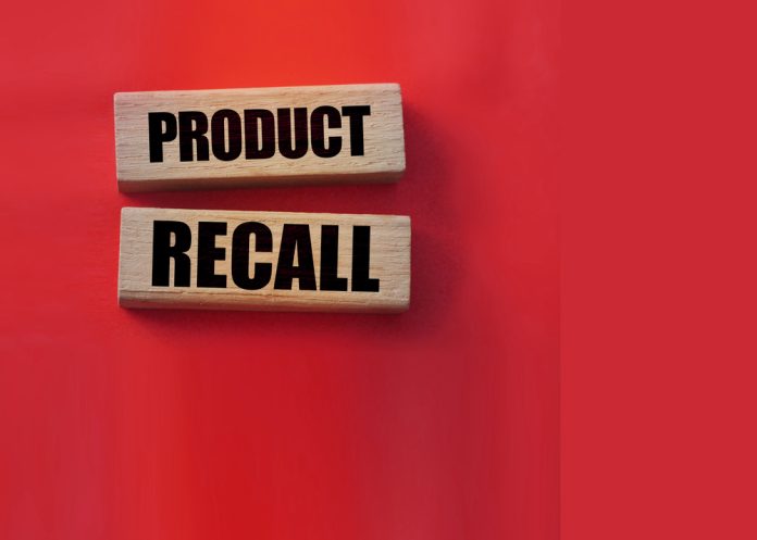 Product recall text on wooden blocks red background