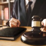 A judge with a hammer and a book