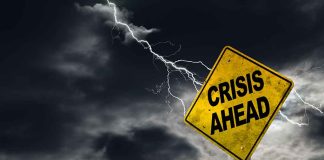 Crisis ahead written on a road sign