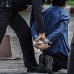 Man arrested and kneeling