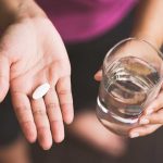 Pill in a woman's hand