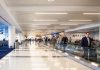 People walking through a busy airport terminal