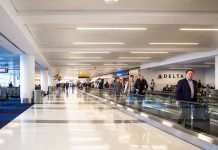 People walking through a busy airport terminal