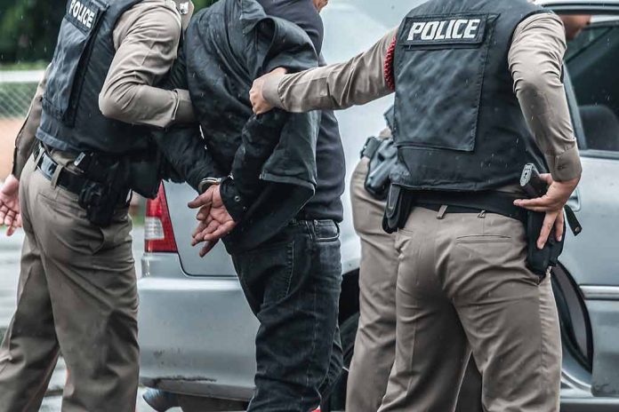 1137889661 featured image Police arresting a person by a car