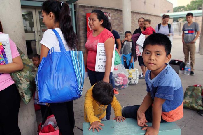 1378764938 featured image People waiting outside carrying bags boys sitting and playing