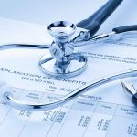 Stethoscope on benefits form with pen