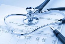 Stethoscope on benefits form with pen