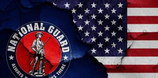 National Guard logo over a distressed American flag