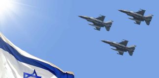 Israeli flag with three fighter jets flying overhead