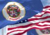 Minnesota state flag with American flag in background