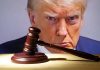 Gavel in front of a serious mans face