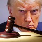 Gavel in front of a serious mans face