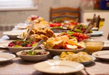 Table set with various colorful dishes and fruits
