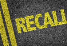 Yellow RECALL text on asphalt background