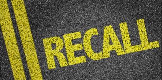 Yellow RECALL text on asphalt background