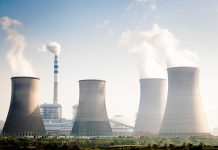 Four cooling towers of a power plant emitting steam