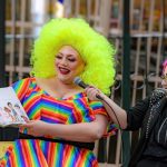 Person reading childrens book with bright colorful outfit