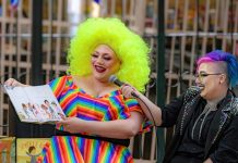 Person reading childrens book with bright colorful outfit