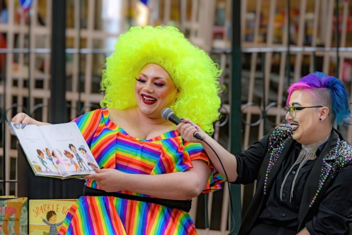 Person reading childrens book with bright colorful outfit