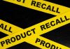 Yellow tape with product recall text on black background
