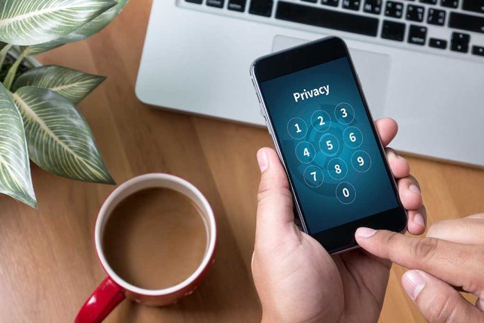 489314119 featured image Typing privacy passcode on smartphone near laptop and coffee