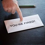 Envelope with YOU'RE FIRED! and pointing finger