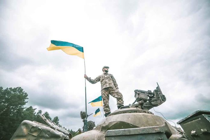 723045559 featured image Soldier on tank holding Ukrainian flag