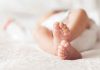 Closeup of baby feet lying on blanket