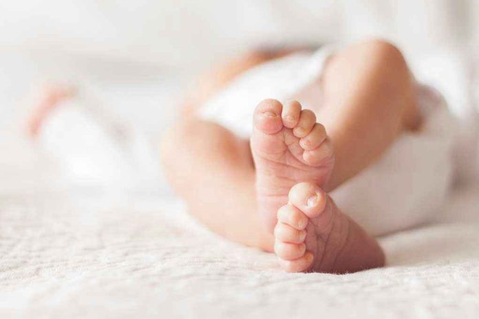 1111986902 Closeup of baby feet lying on blanket