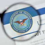 Magnifying glass over Department of Defense logo