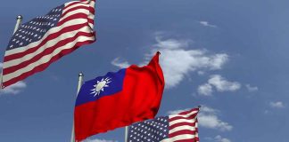 American and Taiwanese flags waving in the sky