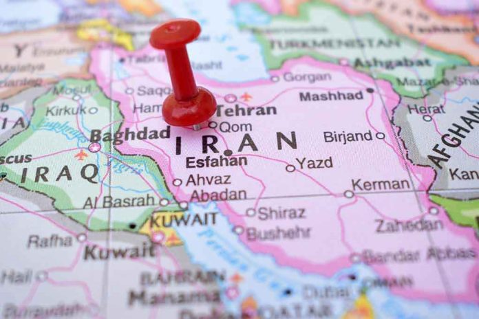 2237379503 Red pushpin marking Iran on a map.