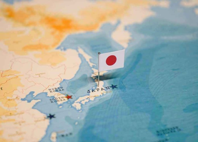 2327414549 Map of Japan with flag pin placed nearby