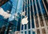 Apple store with glass facade and city reflections