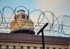 Barbed wire in front of a prison tower