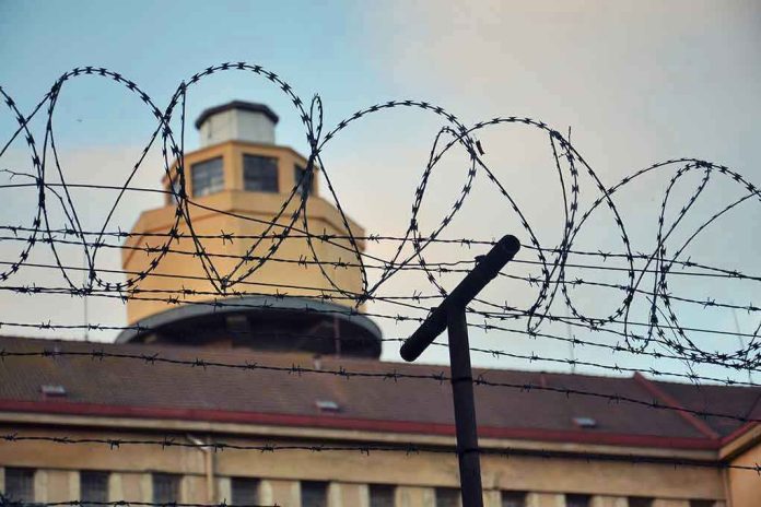 356278409 Barbed wire in front of a prison tower