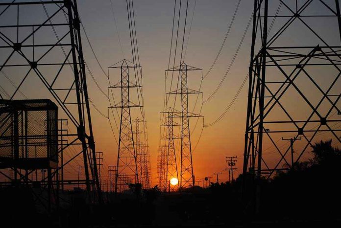 709070596 Transmission towers at sunset