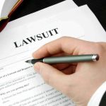 Filling out lawsuit form with pen